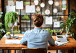 © NORN - Woman at Desk with Laptop and Green Plants.