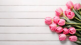 Fototapeta Tulipany - Pink tulips on white wooden background. Copy space