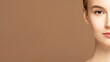 © Beauty Agent Studio - Half of the face beauty cropped portrait of the model with a perfect skin s looking at camera against beige background. Skincare  treatment and spa concept.