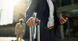 © N Felix/peopleimages.com - Business man, phone and suitcase in street, hands and search for location, travel and transport to airport Corporate employee, smartphone and walk with baggage, luggage or urban sidewalk in Cape Town