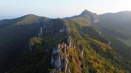 Wall Mural - colorful trees in autumn forest at sulov rocks. mountain landscape nature in slovakia - aerial view