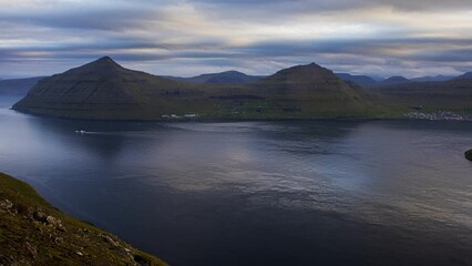 Wall Mural - Time lapse of sunset Klakkur peak, Faroe Islands, Denmark, Europe. Colorful evening seascape of Atlantic Ocean.