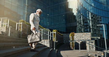 Poster - City, business and stairs with old man, walking and corporate with a briefcase, sunshine and buildings. Elderly person, employee and entrepreneur with urban town, steps and New York with professional