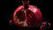Fresh pomegranate with water splashes and drops on black background