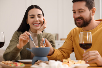 Sticker - Affectionate couple enjoying fondue during romantic date at home