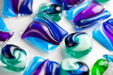 Fototapeta Przestrzenne - Washing capsules, colorful laundry pods. Colorful Soluble capsules with laundry gel detergent and dishwasher soap. Pile of various washing pod capsules. Detergent tablets. Top View, Flat Lay. 