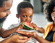 © Lumos sp - child family kitchen food boy son father mother watermelon fruit slice summer organic meal fun preparing healthy diet eating home black