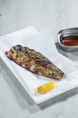 Sticker - Fried mackerel with lemon and soy sauce on white plate