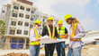 © ฺฺฺBoonterm - Team architects multi ethnic workers men and women meeting brainstorming construction of condominium buildings civil engineers examining blueprints giving advice planning projects housing real estate.