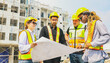 © ฺฺฺBoonterm - Team architects multi ethnic workers men and women meeting brainstorming construction of condominium buildings civil engineers examining blueprints giving advice planning projects housing real estate.