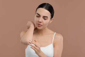 Sticker - Woman with dry skin checking her elbow on beige background