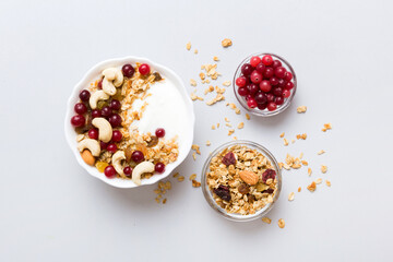 Wall Mural - Healthy breakfast food with granola, yogurt, fruits and nuts. Dessert parfait with dried fruits for breakfast