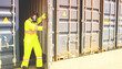 © ฺฺฺBoonterm - Male rescue worker wearing uniform PPE and wear mask to prevent accidents from dangerous stench toxins inside the container that are illegally transported into the country. Open the door carefully.