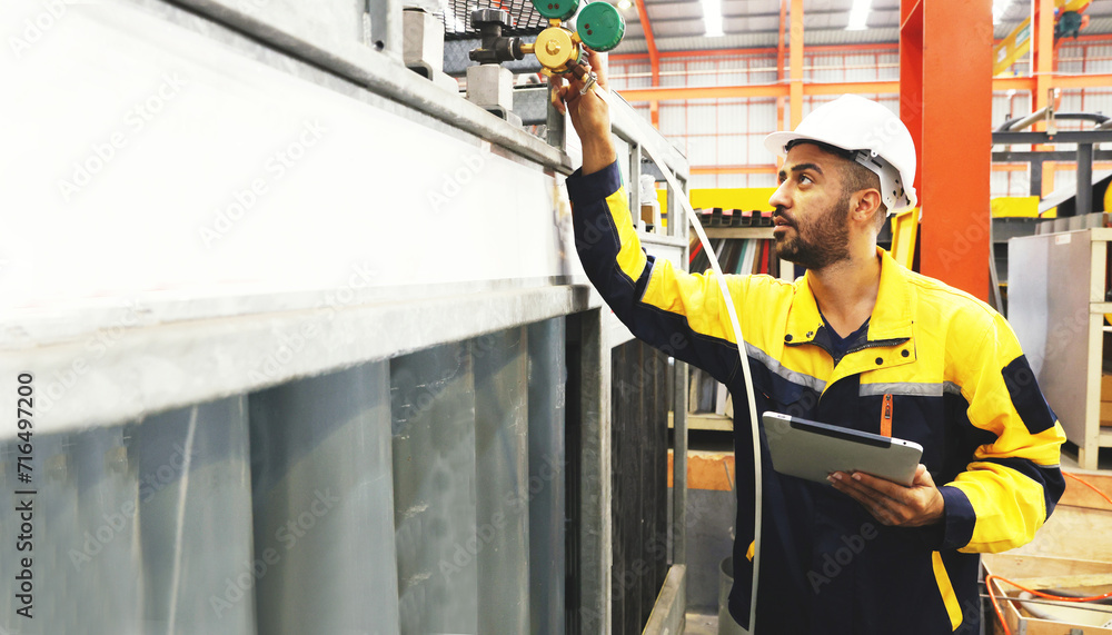 Safety Issue Factory Factory safety : Male technician engineer wearing helmet holds tablet ...