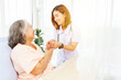 © ฺฺฺBoonterm - Female doctor holds the hand elderly female patient showing positive expressions encouragement good wishes each other heal sick person normal healthy spread happiness together in the hospital.