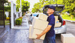 © ฺฺฺBoonterm - Senior male retired asian employee driving delivery truck standing with package ordering products online standing outside the customer's house in the village waiting receive the order with smile face.