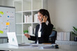 © Natee Meepian - Happy confident businesswoman talking on the phone. Smiling female business person talking work using talking on the phone at office sitting at desk