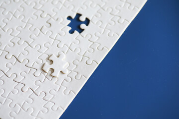 Wall Mural - Clean puzzle elements on the background. Empty puzzle piece on the table. Teamwork concept.