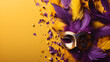 purple and yellow venetian or masquerade mask, feather, confetti. over on the purple background. free space for text advertising.
