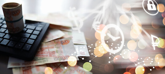 Wall Mural - Russian rubles are on the table next to the computer, Notepad in the office or Bank. Savings and investments in the conditions of sanctions and inflation.