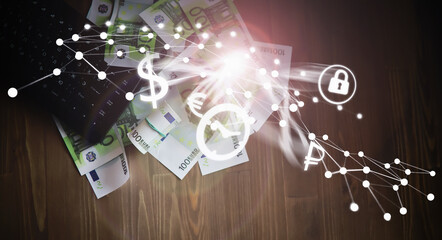 The work of a programmer and blogger on the Internet. Computer keyboard and a scattering of 100 euro bills on the table.