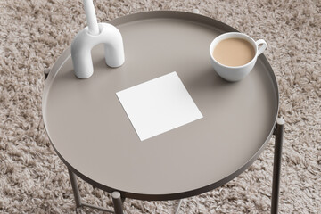 Sticker - Square invitation card mockup with a candle and a cup of coffee on the beige table. 5x7 ratio, similar to A6, A5.