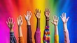 Multicolored raised hands against a rainbow background. The concept of unity, diversity, and inclusion.