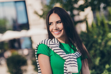 Sticker - Photo of charming good mood lady wear green t-shirt walking enjoying sunny weather smiling outside urban city street