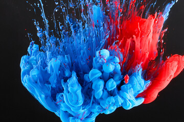 Wall Mural - Abstract Blue and red paint in water on black background