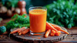 Freshly squeezed carrot juice in a transparent glass on a wooden background. The benefits of plant foods for human health. Diet and balanced nutrition. Carotene and veganism