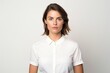 © CogniLens - Portrait of a content woman in her 30s donning a classy polo shirt against a white background. AI Generation