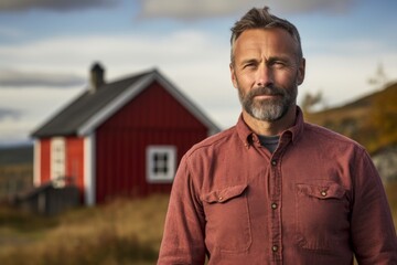Wall Mural - Portrait of a satisfied man in his 50s dressed in a relaxed flannel shirt against a quiet countryside landscape. AI Generation