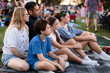 © Austockphoto - Family watching Christmas carols together on a picnic rug