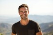 © CogniLens - Portrait of a grinning man in his 30s dressed in a casual t-shirt against a panoramic mountain vista. AI Generation
