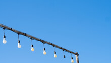 Shimmering Lamps In Series On A Evening, Blue Sky With Cloud