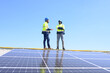 © eakarat - A team of engineers is laying out the installation of an outdoor solar panel system. Installing solar cells on the roof. Solar panels on the roof Workers install eco-technology photovoltaic power plan