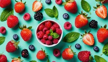  A Bowl Of Strawberries, Raspberries, Blueberries And Raspberries On A Blue Background With Mint Leaves And Strawberries In The Center Of The Bowl.