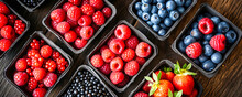Assorted Fruit Trays On Table, Raspberries, Strawberries, Blackberries, Blueberries