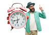 © San4ezz007 - Young crazy bearded charismatic hipster holding a closeup of a huge pink alarm clock pointing at it isolated. It's time to.