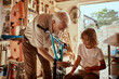 © Marko Geber - Grandfather and grandson fixing a bike in the garage