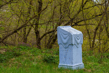 Stone platform for reading prayers in the forest near the monastery. Background with selective focus