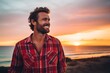 © CogniLens - Portrait of a happy man in his 30s dressed in a relaxed flannel shirt against a vibrant beach sunset background. AI Generation