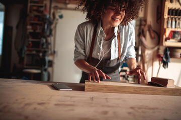 Wall Mural - Artisan woman dancing in woodworking workshop