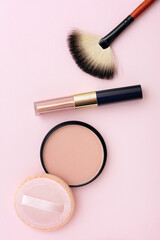 Wall Mural - Mineral compact powder, make-up brush and sponge, isolated on a pink background