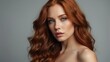 © sevenSkies - Beautiful portrait of sensual woman with long wavy red hair for make up cosmetics ad concept, plain background from Generative AI