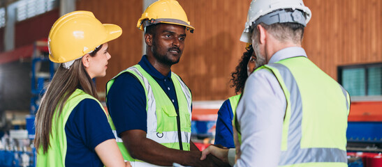 Wall Mural - Team engineers and foreman stack hand and shake hands to show success at factory machines. Worker industry join hand for collaboration.