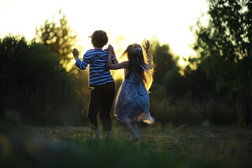 Wall Mural - Children walk in the summer in nature. Child on a sunny spring morning in the park. Traveling with children.