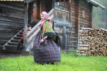 Wall Mural - Traditional Slavic rituals in the rustic style. Outdoor in summer. Slavic village farm. Peasants in elegant robes.