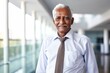 Portrait of a grinning indian elderly 100 years old man wearing a lightweight running vest against a sophisticated corporate office background. AI Generation