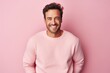 © CogniLens - Portrait of a joyful man in his 30s wearing a cozy sweater against a solid pastel color wall. AI Generation